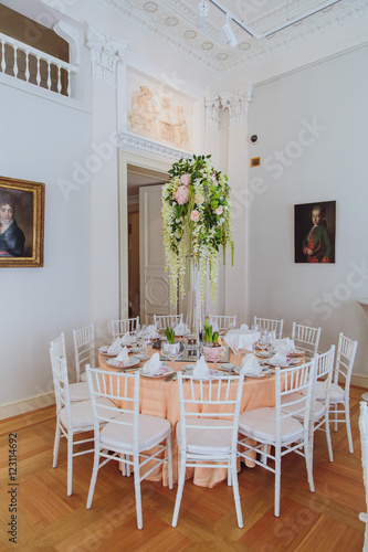 White garlands hang from the green bouquet which stands on the o