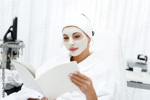 Pretty woman enjoying skin care treatment at spa