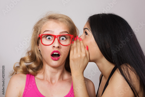 Woman sharing secret with her friend