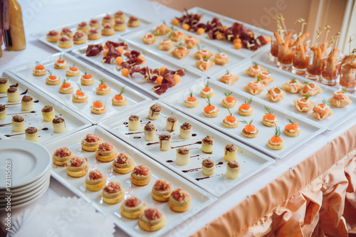 Different kinds of salted appetizers lie on the square plates