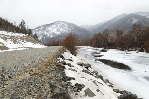 Icebound river on a cloudy spring day. Irkutsk Region