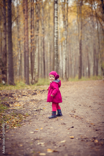 Little girl in autumn park