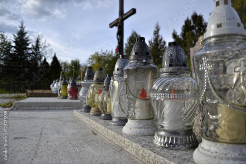 Votive candles lantern on the grave in Slovak cemetery. All Saints' Day. Solemnity of All Saints. All Hallows eve. 1st November. Feast of All Saints. Hallowmas. All Souls' Day