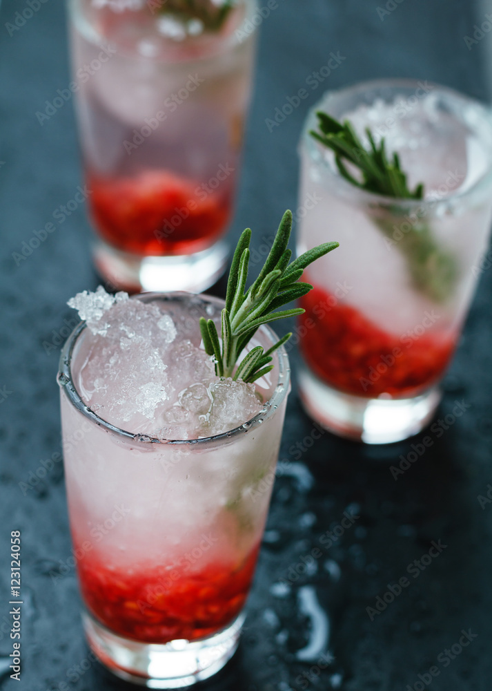 Close-up shot of refreshing berry cocktails with ice and rosemary Close-up shot of refreshing berry cocktails with ice and rosemary