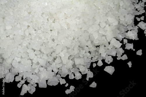 Photos Rock Salt on black stone background. Macro shot.