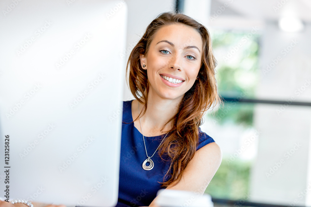 Portrait of businesswoman working at her desk in office Portrait of businesswoman working at her desk in office