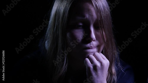 Wallpaper Mural Depressed teen girl is crying in the dark. 4K UHD. Torontodigital.ca