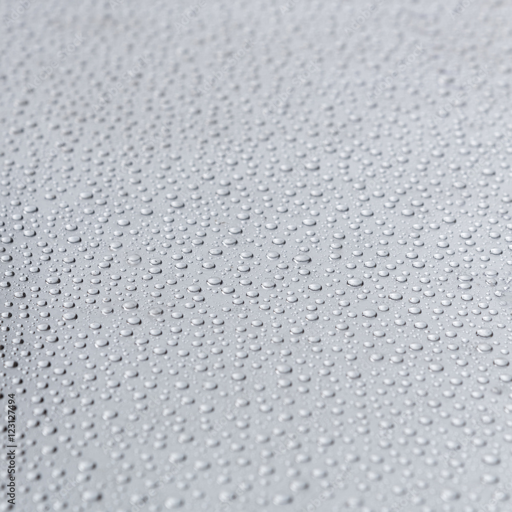 close up rain water drop falling on roof car close up rain water drop falling on roof car