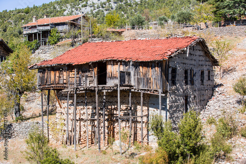 Ruins of abandoned buttoned houses in Ghost town of Ormana, Antalya, Turkey photo