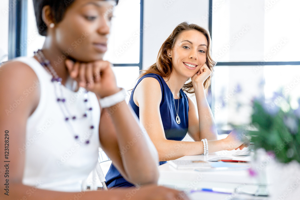 Fototapeta premium Young businesswoman sitting at desk and working
