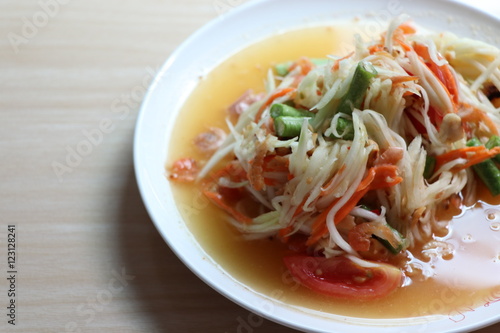 Papaya salad, Som Tam Thai very delicious and spicy in the white plate 