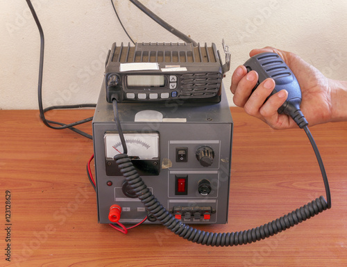 hand of Amateur radio holding speaker and press for radio communication theme