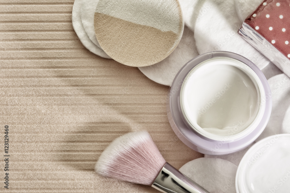 Tone cream and cotton pads on a pink background. Tone cream and cotton pads on a pink background.