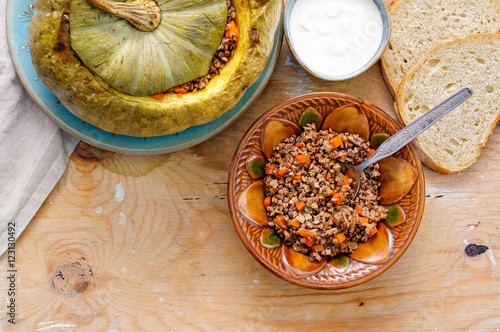 Tasty autumn stuffed pumpkin with buckweat and mushrooms photo