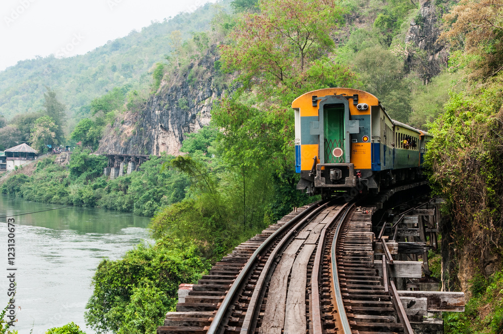 trains running on death railways track crossing kwai river in kanchanaburi thailand this