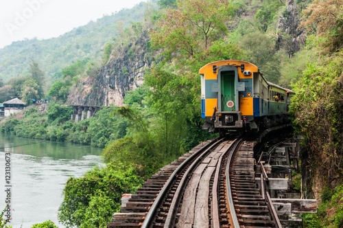 trains running on death railways track crossing kwai river in kanchanaburi thailand this railways important destination of world war II history builted by soldier prisoners photo