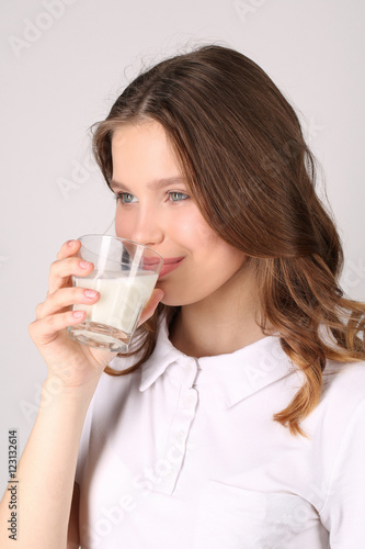 Model drinking milk. Close up. White background