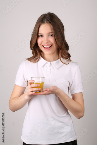 Lady posing with glass of juice. Close up. White background