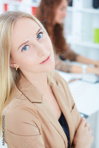Portrait of smiling businesswoman, with female colleague on the background.Top view.