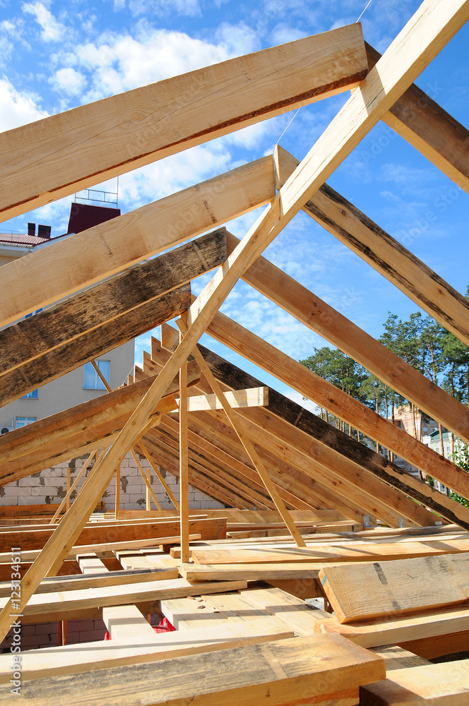 New residential construction home framing against a blue sky. Roofing construction. installation of insulation wool. white building blocks. unfinished plaster. New residential construction home framing against a blue sky. Roofing construction. installation of insulation wool. white building blocks. unfinished plaster.