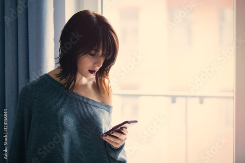 woman with mobile phone at home