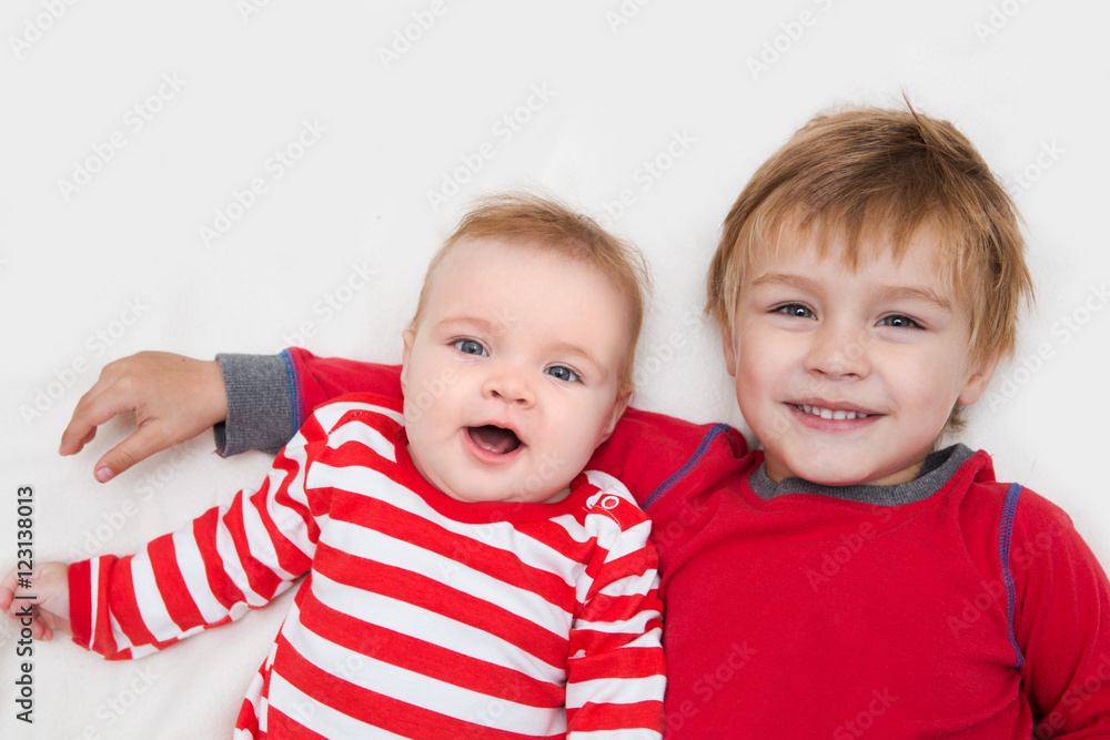 portrait of little boy with newborn sister, family concept
portrait of little boy with newborn sister, family concept
