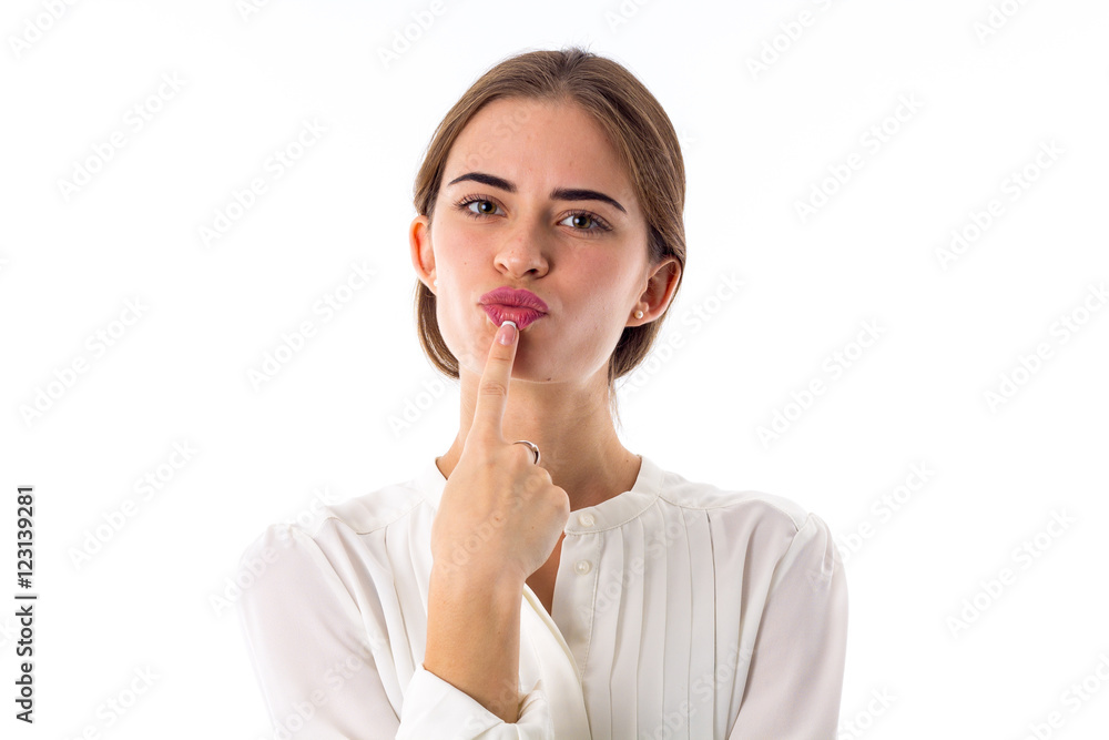 Woman holding a finger near her lips Woman holding a finger near her lips