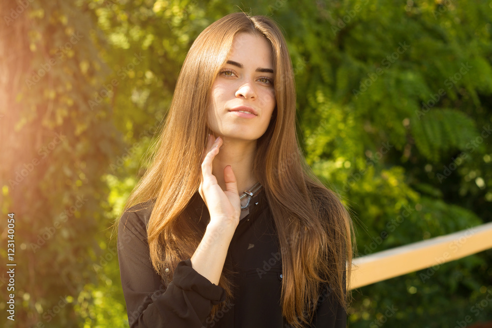 Young woman on the background of trees Young woman on the background of trees
