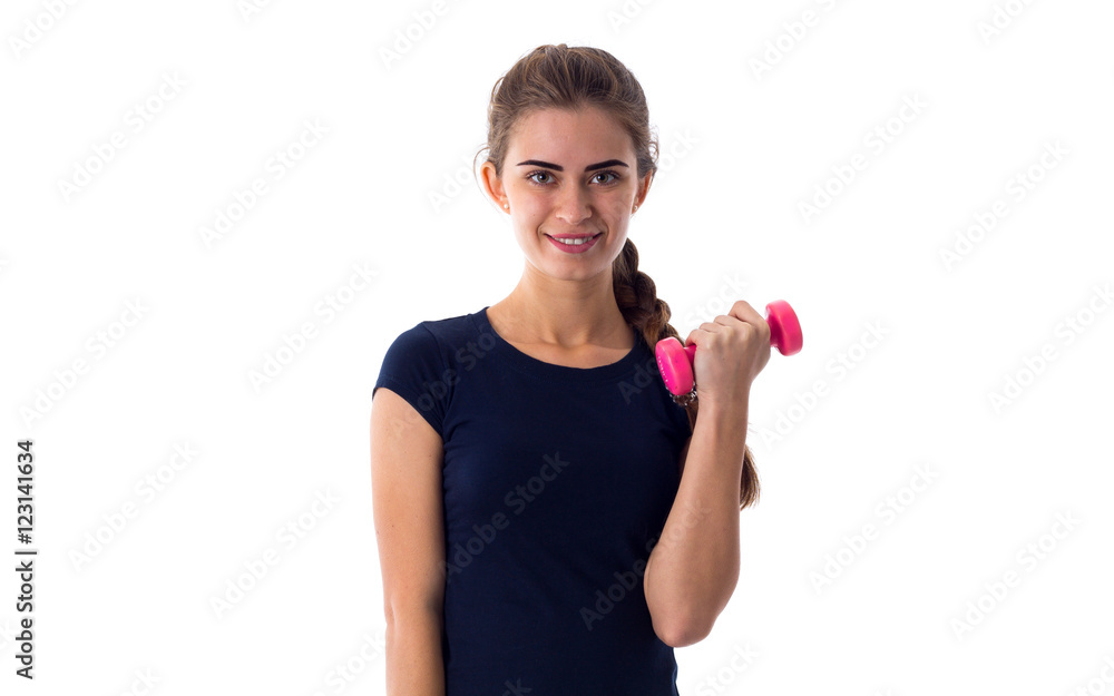 Smiling woman holding a dumbbell Smiling woman holding a dumbbell