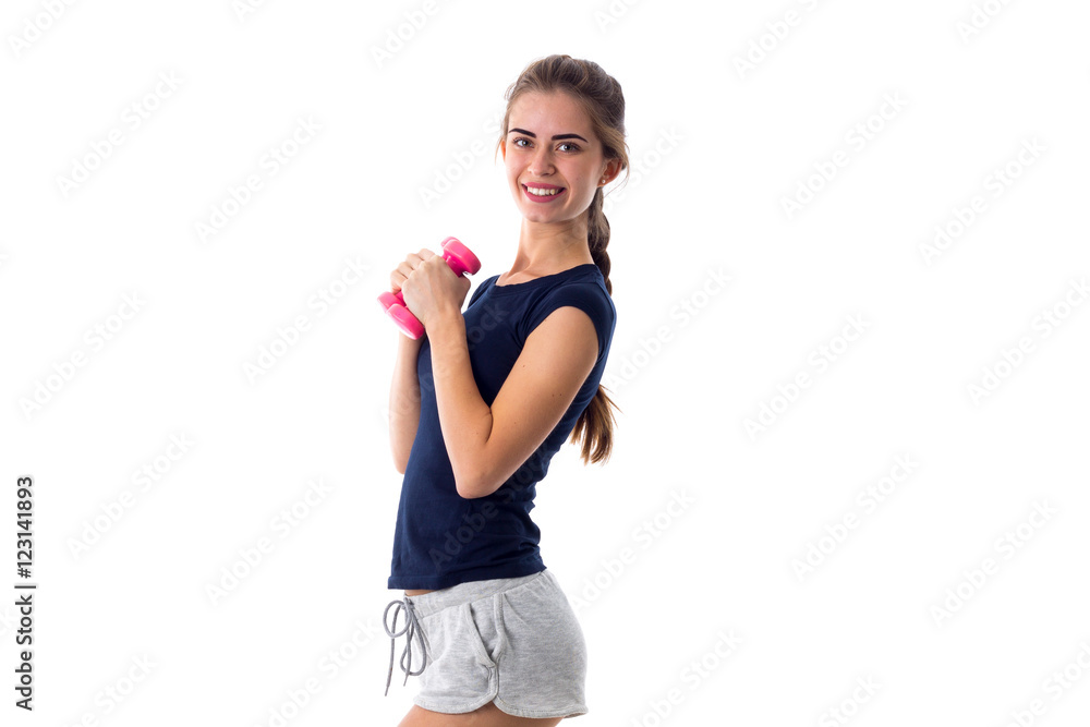 Smiling woman holding two dumbbells Smiling woman holding two dumbbells