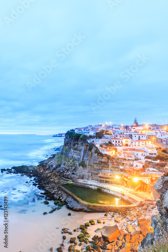 Azenhas do Mar village at dusk with stormy sea and dark clouds
