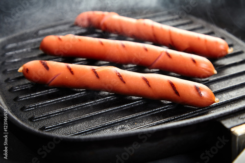 Hot smoking Vienna sausages in the pan