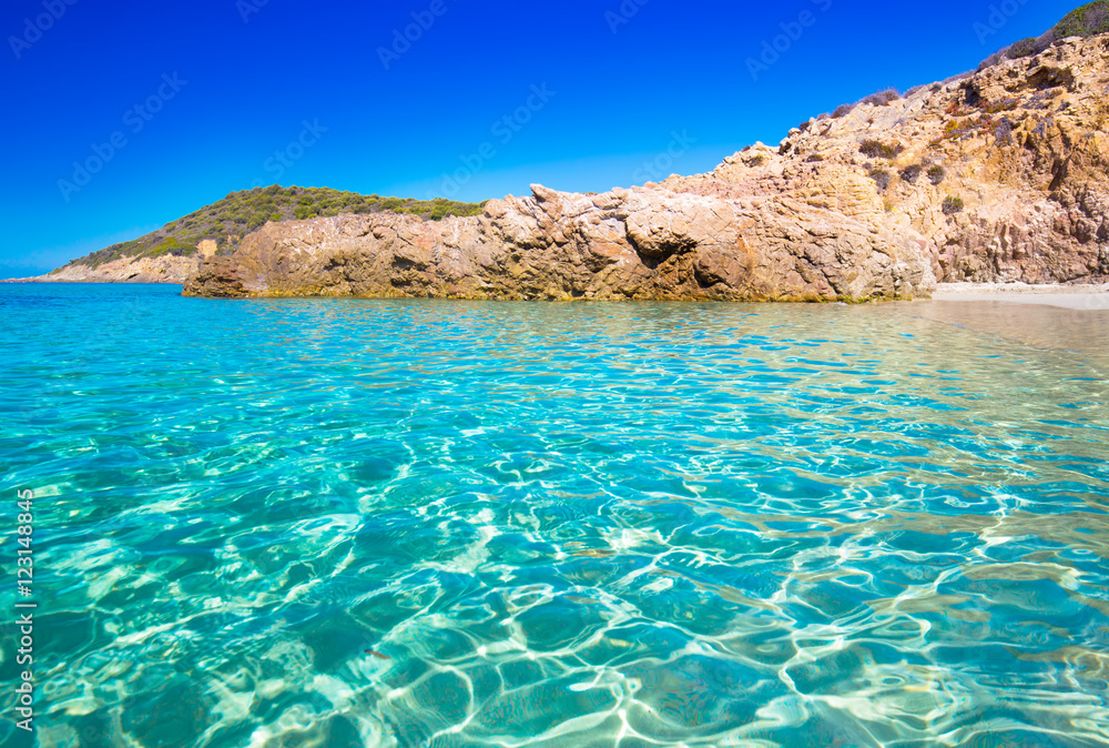 Sandy beach with rocks in Corsica, France.