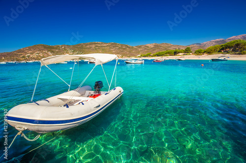 Motor boats with sandy beach near Sagone, Corsica, France