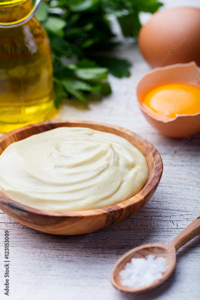 Homemade mayonnaise, mayo in a wooden bowl. White background. Homemade mayonnaise, mayo in a wooden bowl. White background.