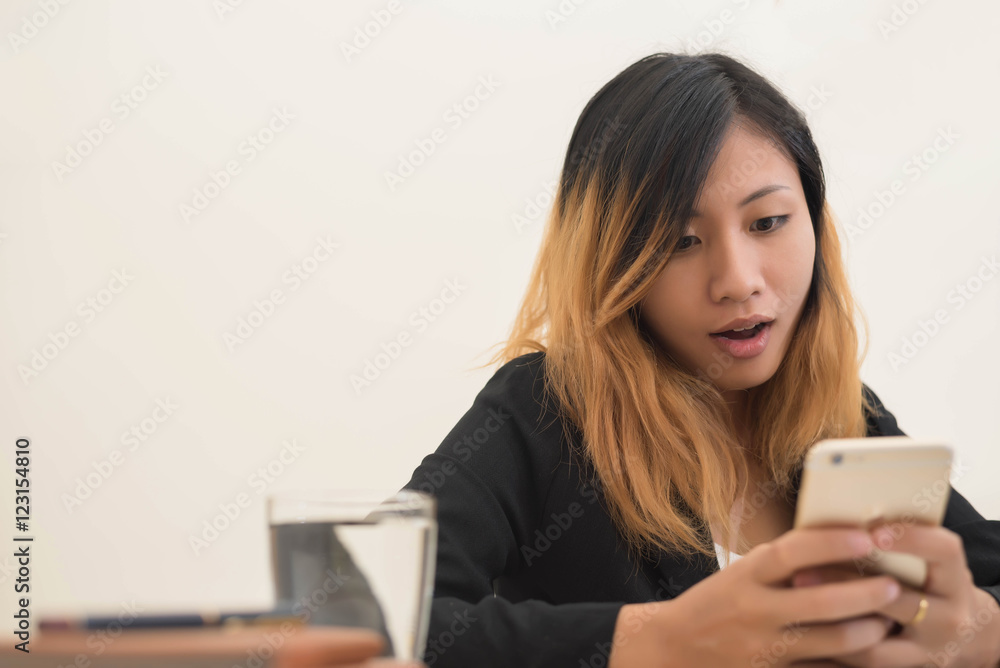 young business woman working on his laptop and using smart phone young business woman working on his laptop and using smart phone