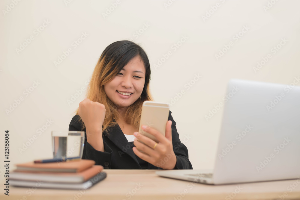 young business woman working on his laptop and using smart phone young business woman working on his laptop and using smart phone