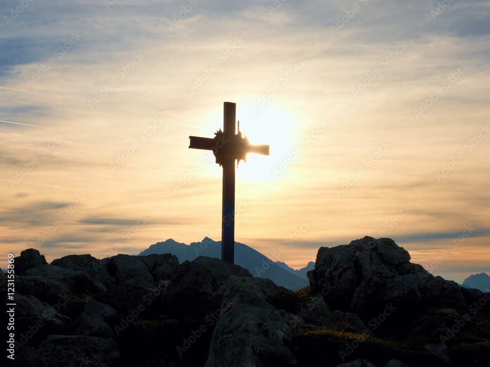 Iron cross at mountain top in alp. Monument to the dead climbers