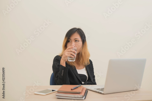 business woman working on his laptop and drinking water.