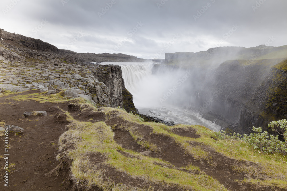 Dettifoss is the most impressive waterfall of Iceland and of Europe. About 30 km before flowing into the Bay Öxarfjörður in northern Iceland, the river Jökulsá á Fjöllum falls by more waterfalls