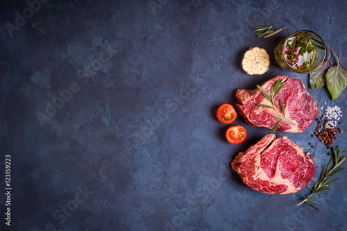 Fototapeta Naklejka Na Ścianę i Meble -  Raw meat steak on rustic concrete background ready to roasting