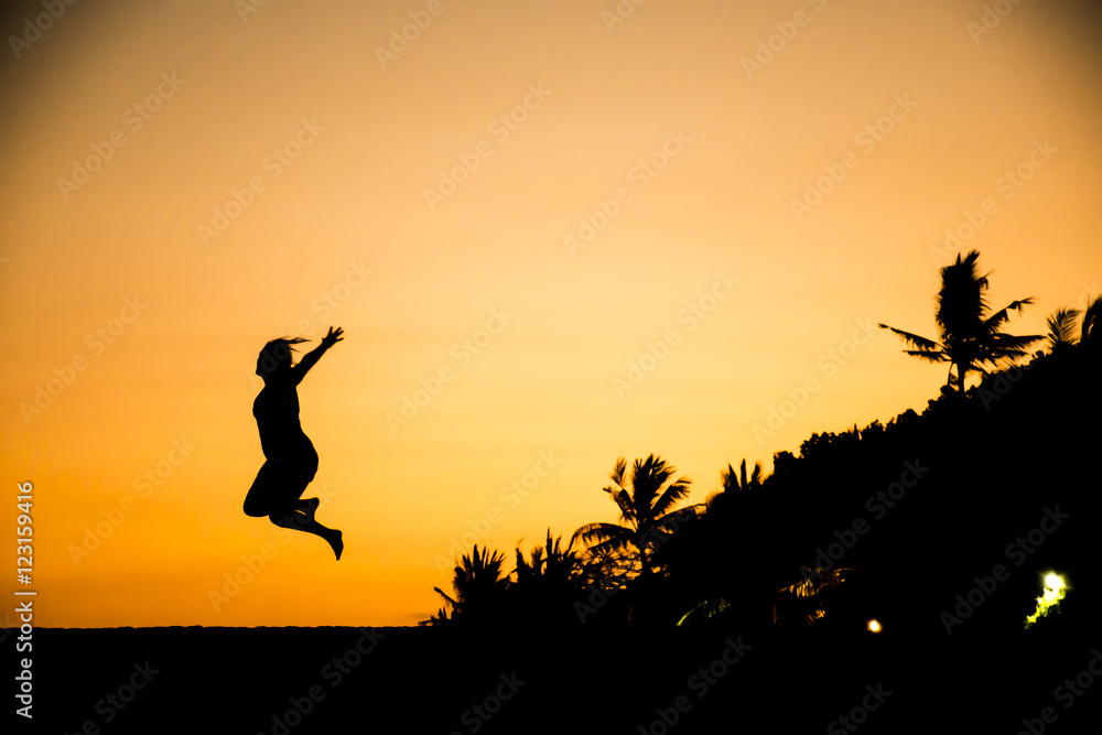 Bali jumping girl silhouette Sanur Beach sunset