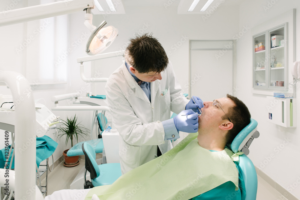 Obraz premium Dentist is working on his patient