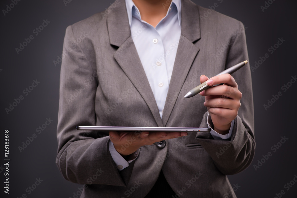 Businesswoman working on tablet computer in business concept Businesswoman working on tablet computer in business concept
