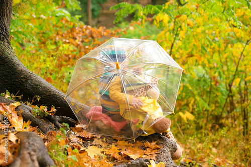 toddler walking in rainy autumn park
