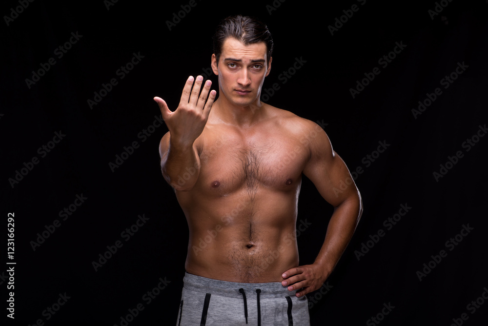 Fototapeta premium Ripped muscular man on black background