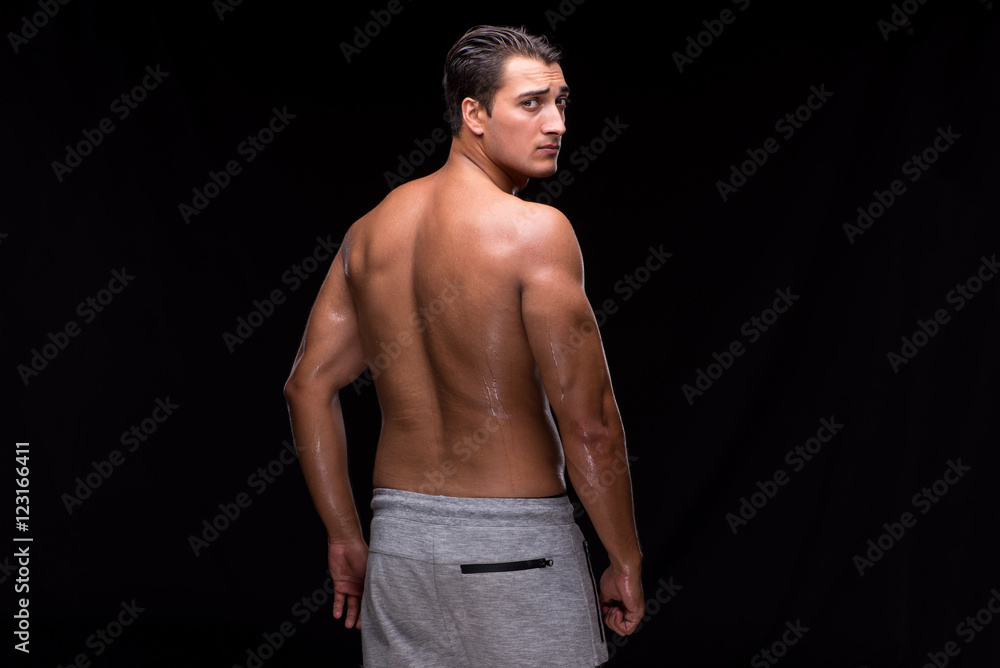 Naklejka premium Ripped muscular man on black background