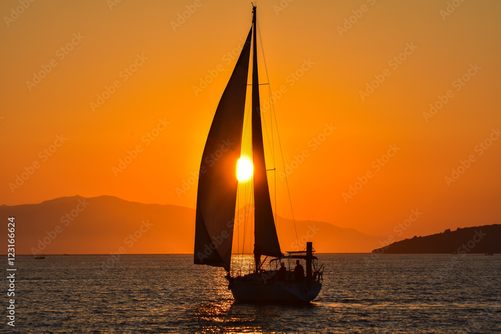 Sailing boat on the sea at sunset.