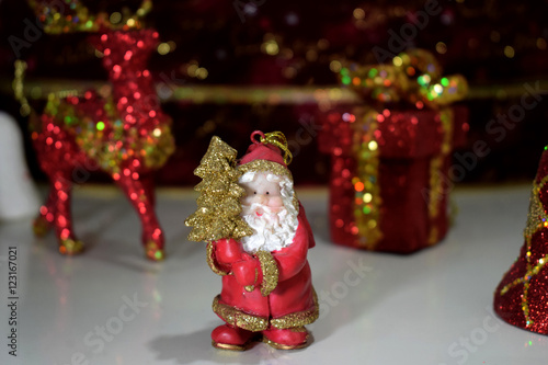 Santa Claus figure with christmas gift and reindeer 