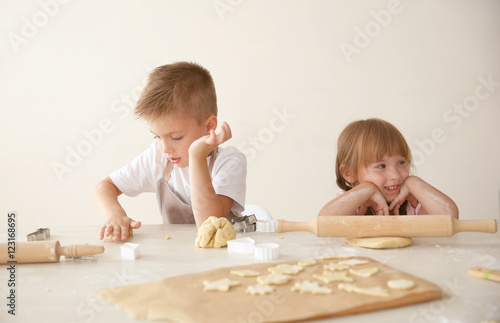 Kids making biscuits in kitchen